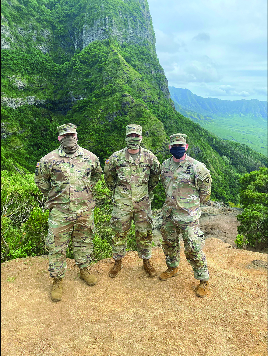 The 25th ID OSJA practiced social distanc - ing and promoted CPL Michael Rangel, 1-27 Infantry Regiment “Wolfhounds,” to sergeant. From left to right: SFC Andrew Kelleher, 2d Infantry Brigade Senior Paralegal NCO; SGT Michael Rangel; and MAJ Samuel Grabill, BJA. The OSJA Ohana joined them via Microsoft Teams.